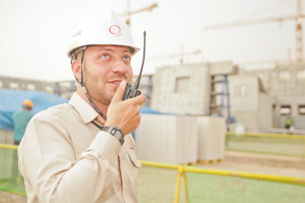 Man speaking in walkie talkie on construction site